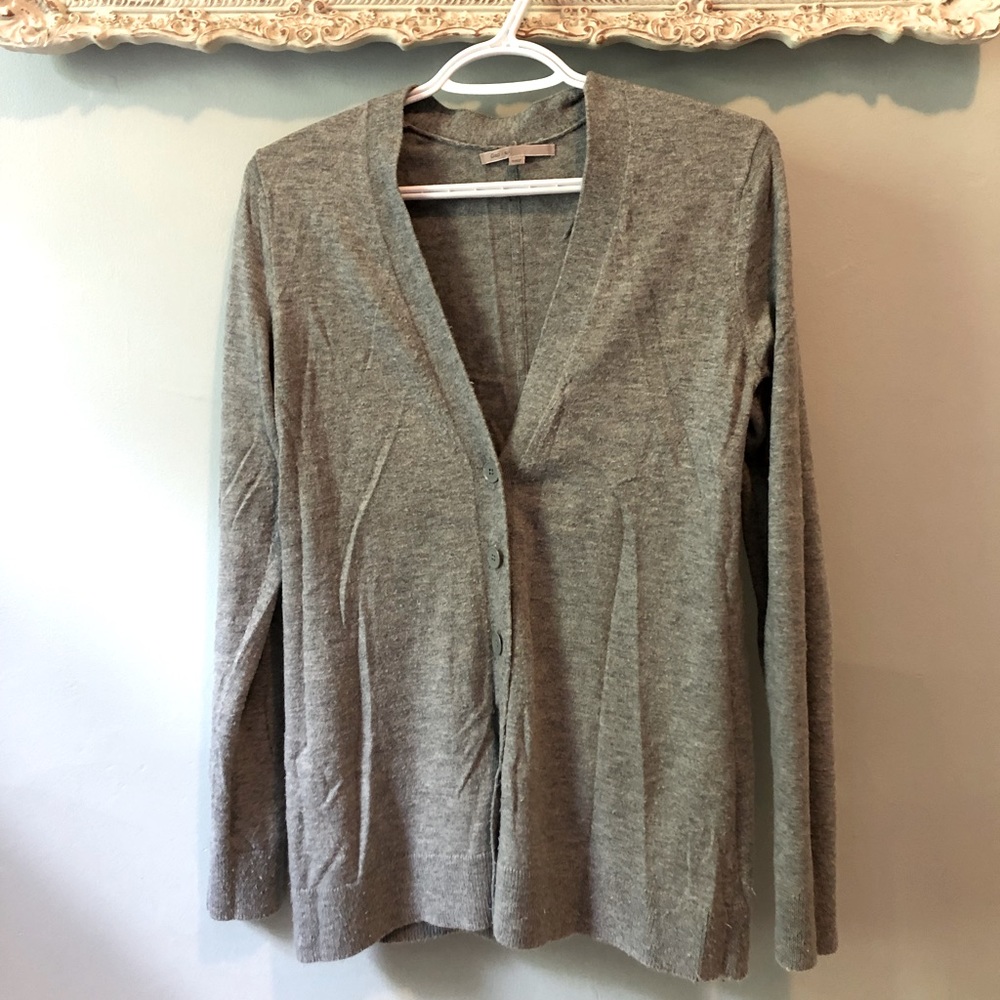 Long sleeved, button up grey sweater.